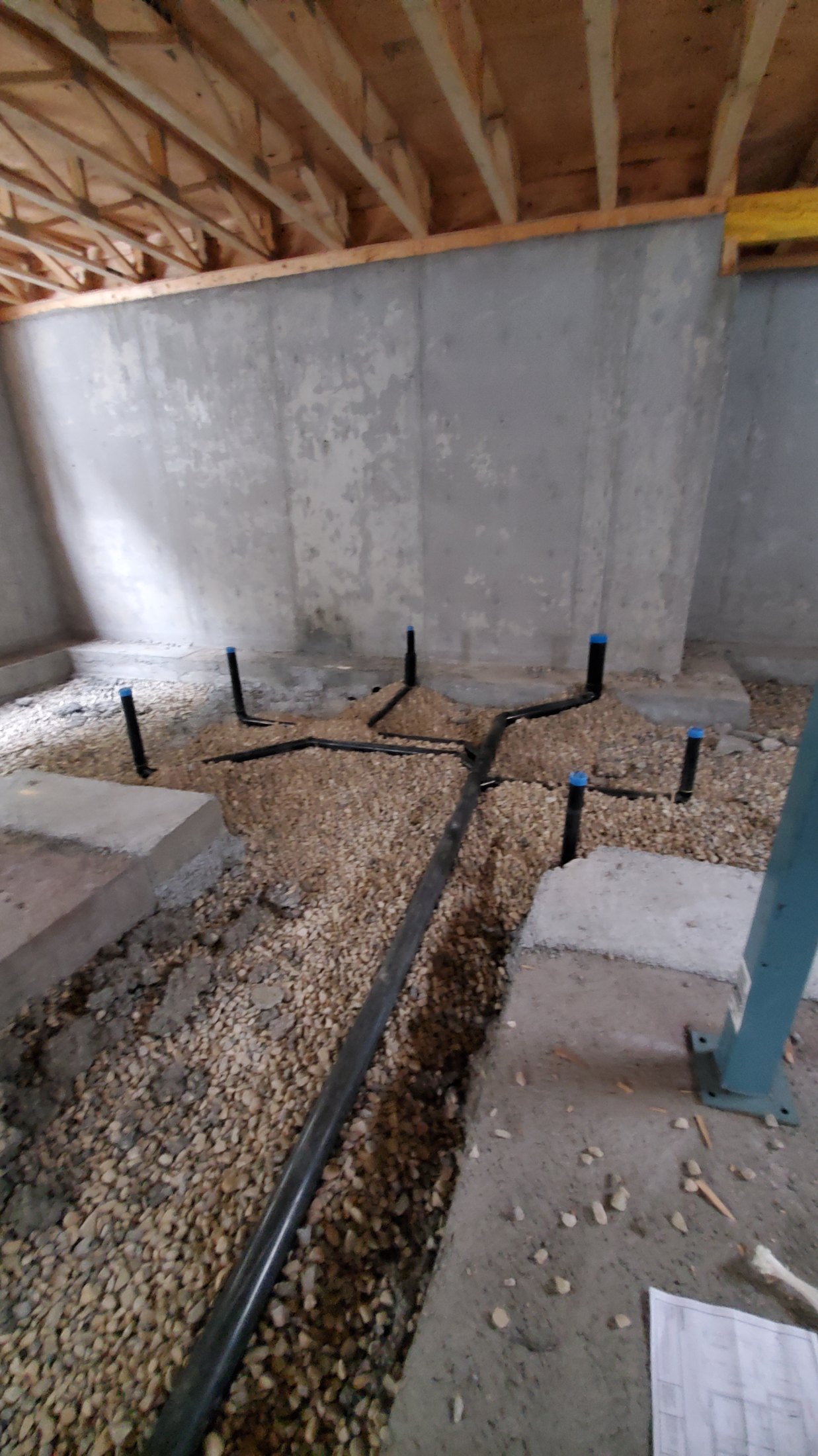Secondary suite plumbing rough-in in a Calgary basement by DNB